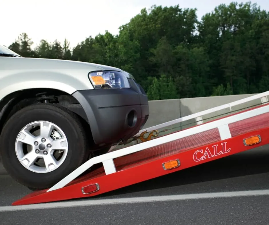 Washington tow truck loading a vehicle on a residential street